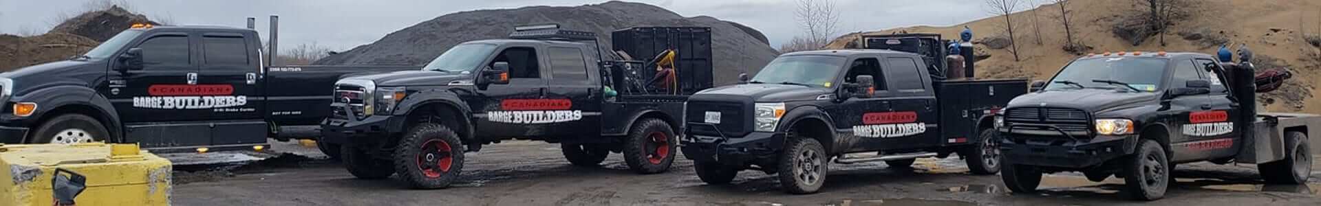 Canadian Barge Builders - Line up of work trucks all with company info on them.jpeg